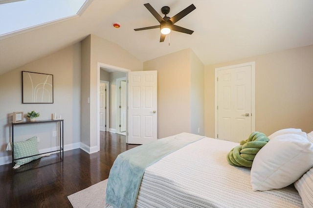 bedroom featuring wood finished floors, vaulted ceiling, baseboards, and a ceiling fan