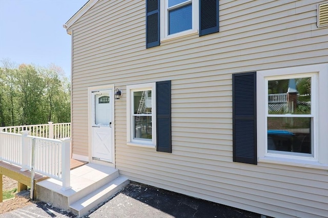 view of exterior entry with a wooden deck