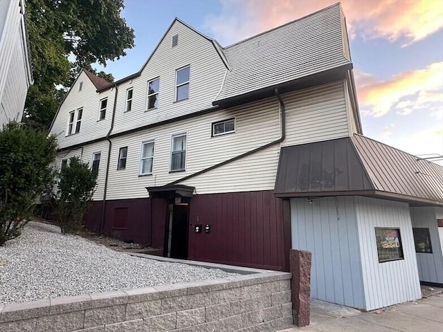 1025 Main St, Worcester, MA 01603 - view of property exterior with a metal roof and a standing seam roof