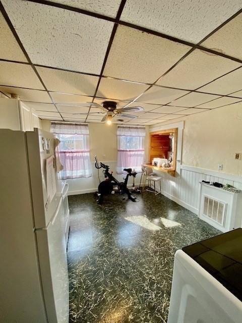 1025 Main St, Worcester, MA 01603 - dining area featuring a drop ceiling, a ceiling fan, wainscoting, and tile patterned floors