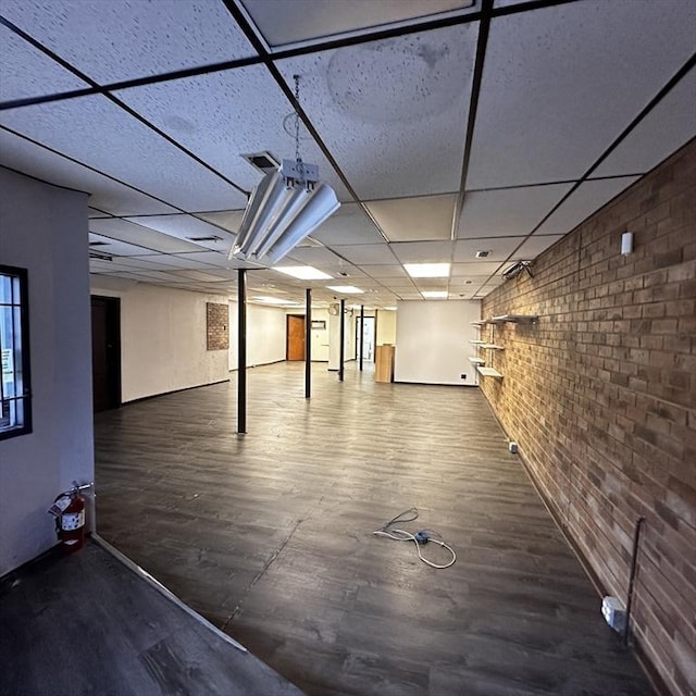 1025 Main St, Worcester, MA 01603 - basement with brick wall, wood finished floors, and a drop ceiling