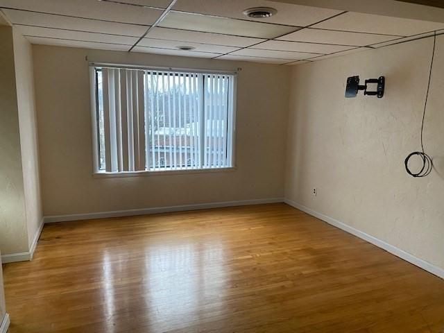 1025 Main St, Worcester, MA 01603 - unfurnished room with a paneled ceiling and wood finished floors
