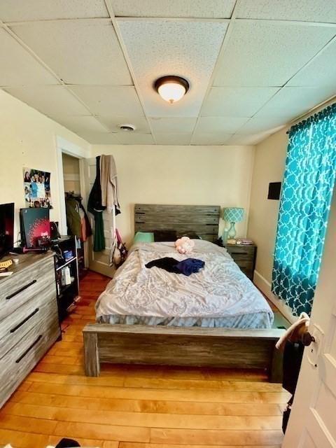 1025 Main St, Worcester, MA 01603 - bedroom with a drop ceiling and wood finished floors