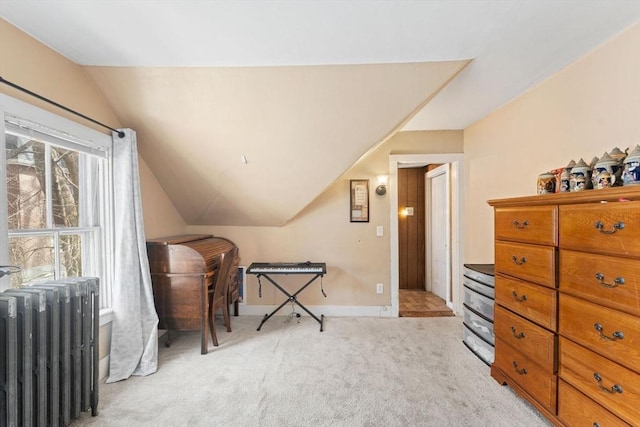 living area featuring light carpet, radiator, baseboards, and lofted ceiling