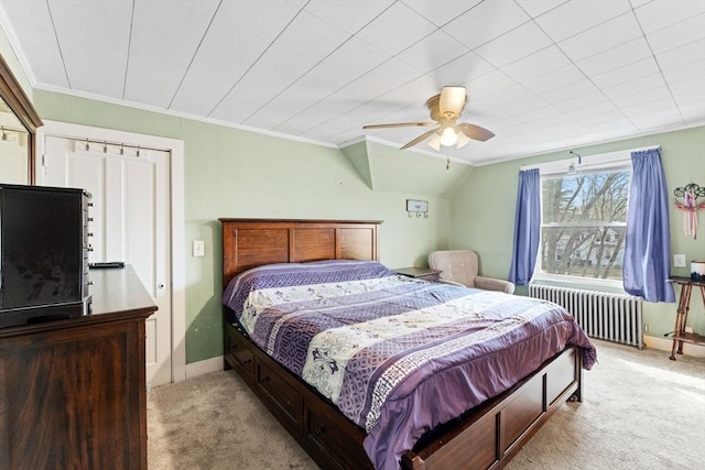 bedroom with ornamental molding, radiator, and light carpet