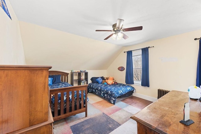 bedroom with vaulted ceiling, radiator heating unit, a ceiling fan, and baseboards