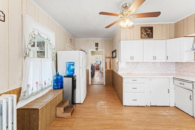 kitchen with radiator, freestanding refrigerator, a ceiling fan, and crown molding