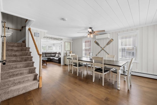 1091 Tobey St, New Bedford, MA 02745 - dining space featuring crown molding, a wall mounted AC, a ceiling fan, wood-type flooring, and stairs