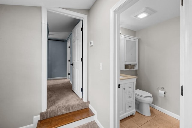 1091 Tobey St, New Bedford, MA 02745 - bathroom featuring vanity, toilet, baseboards, and tile patterned flooring
