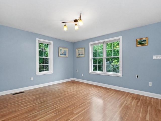 4 University Park, Waltham, MA 02453 - spare room with plenty of natural light, baseboards, and light wood-style flooring