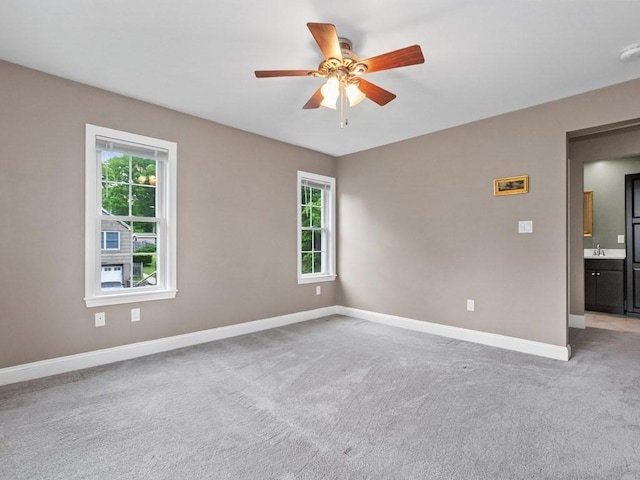 4 University Park, Waltham, MA 02453 - unfurnished room featuring a ceiling fan, baseboards, light colored carpet, and a sink