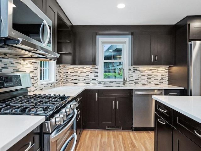 4 University Park, Waltham, MA 02453 - kitchen with stainless steel appliances, a sink, light countertops, light wood-style floors, and recessed lighting