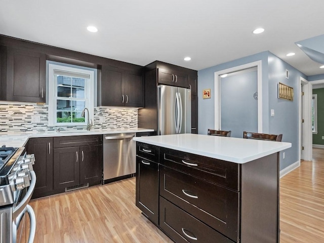 4 University Park, Waltham, MA 02453 - kitchen with appliances with stainless steel finishes, a sink, tasteful backsplash, light wood-type flooring, and recessed lighting