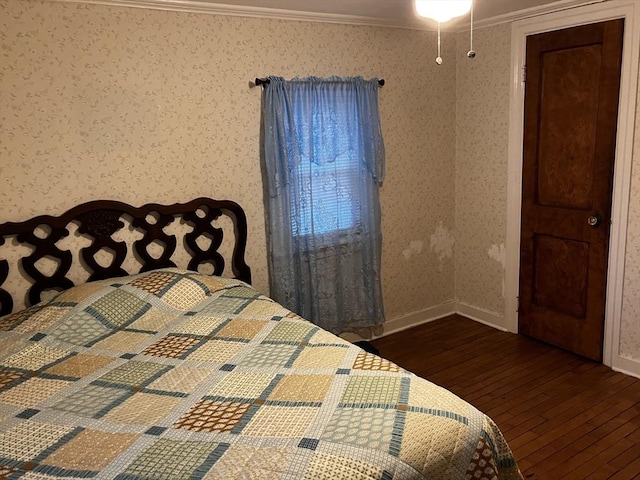 bedroom with wallpapered walls, baseboards, ornamental molding, and hardwood / wood-style floors