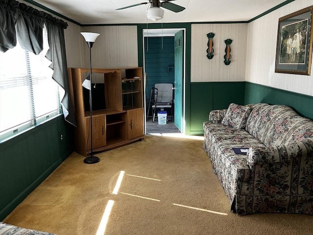 carpeted living area featuring a ceiling fan