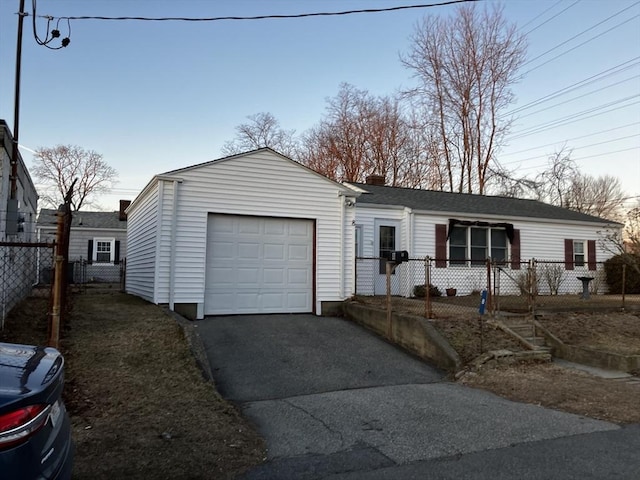 view of front of property with a garage, driveway, a chimney, and fence