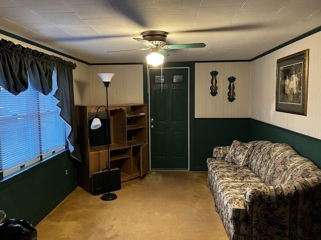 living area featuring light carpet and ceiling fan