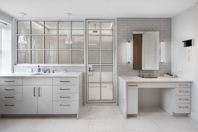 bathroom with tile patterned flooring, vanity, and tile walls