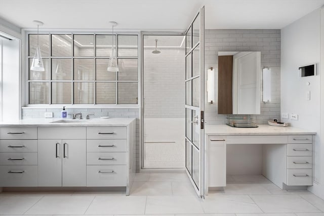 bathroom featuring tile patterned flooring, decorative backsplash, tiled shower, and vanity