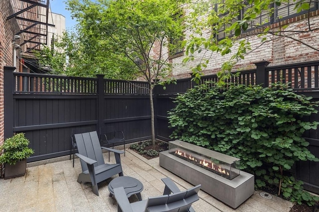 view of patio featuring a fire pit and a fenced backyard