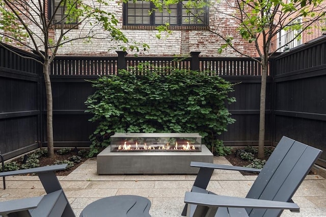 view of patio / terrace featuring a fire pit and a fenced backyard