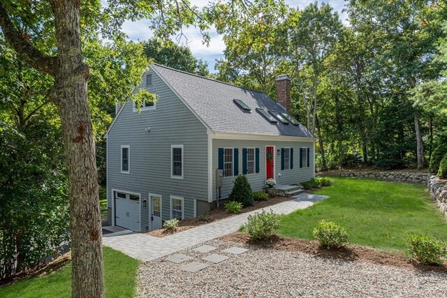 view of front of property featuring a garage and a front yard