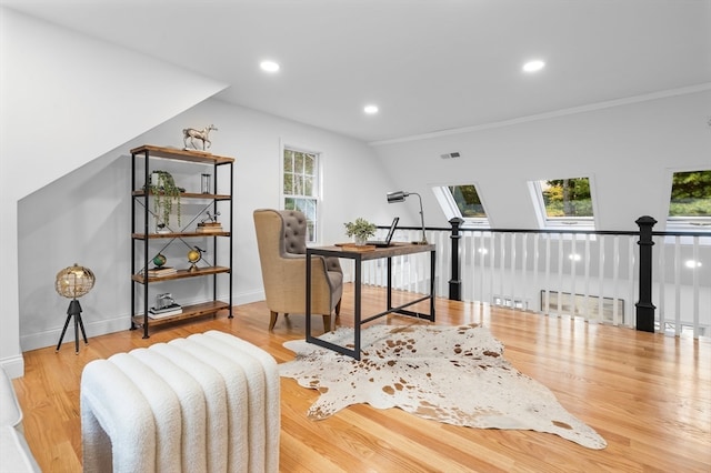 office area featuring crown molding, light hardwood / wood-style floors, and a skylight