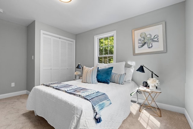 bedroom featuring light carpet and a closet