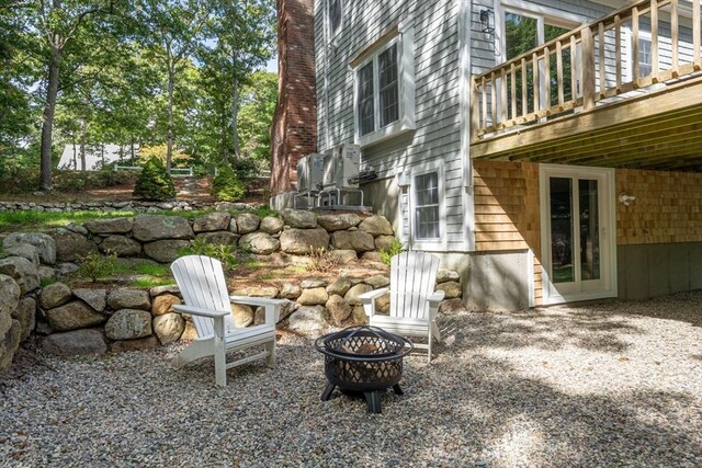 view of yard featuring a deck and an outdoor fire pit