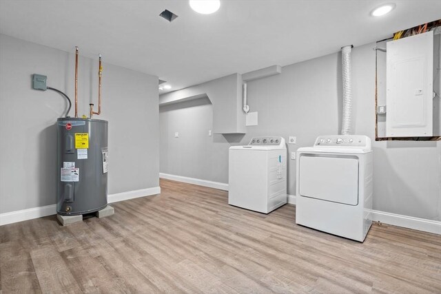 laundry room featuring light wood-type flooring, electric water heater, electric panel, and washer and clothes dryer