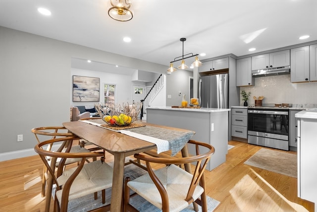 dining space featuring light wood-type flooring