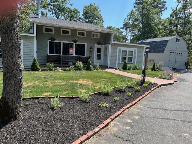390 Brackett Rd, Eastham, MA 02642 - view of front facade with an outdoor structure and a front yard