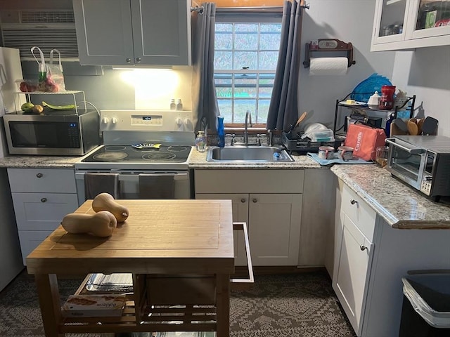 390 Brackett Rd, Eastham, MA 02642 - kitchen with range with electric stovetop, stainless steel microwave, a sink, and light countertops