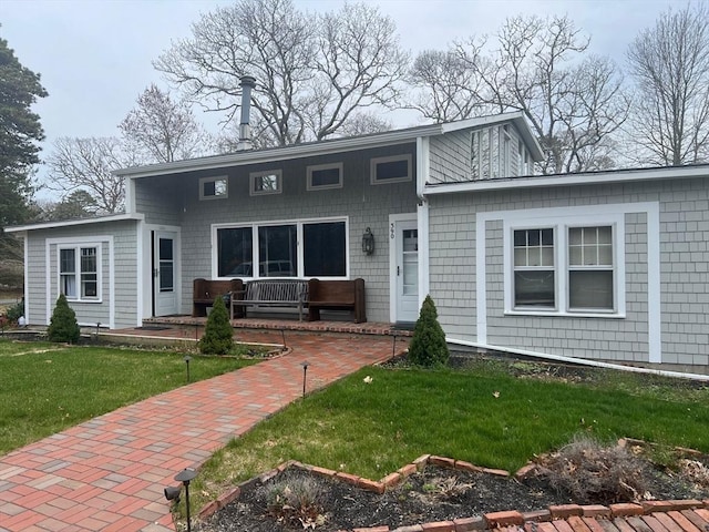 390 Brackett Rd, Eastham, MA 02642 - view of front facade with a front yard and covered porch
