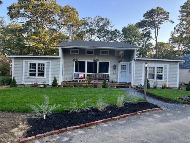 390 Brackett Rd, Eastham, MA 02642 - view of front of house featuring a front lawn and covered porch