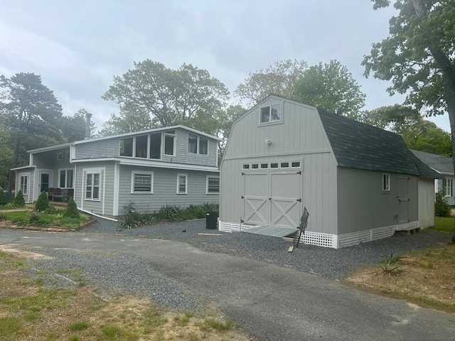 390 Brackett Rd, Eastham, MA 02642 - view of front of home with a garage and a gambrel roof