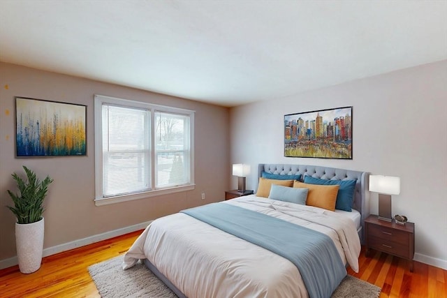 bedroom with light wood-style flooring and baseboards