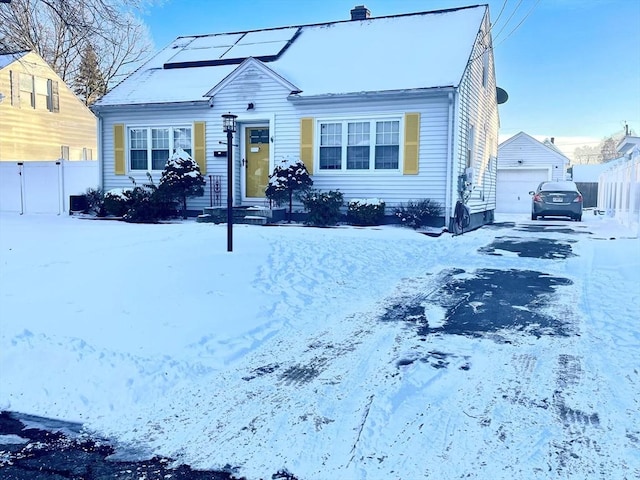 view of front facade featuring a garage and an outdoor structure