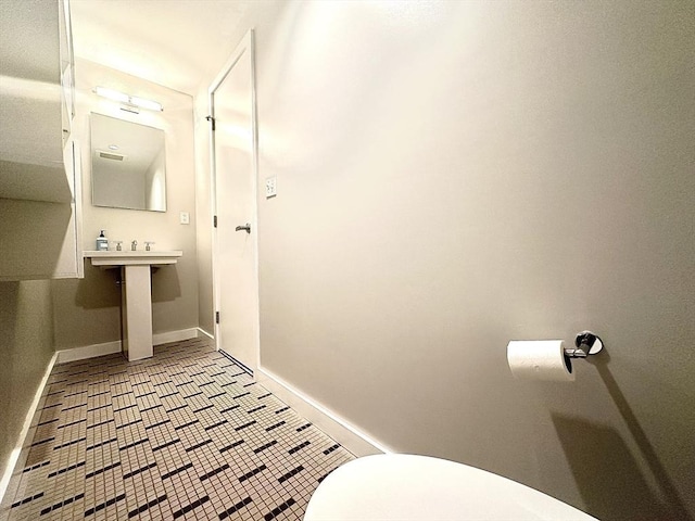 bathroom with tile patterned floors and toilet