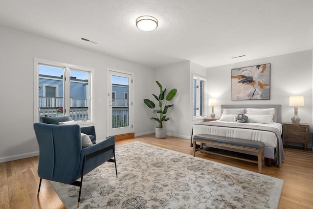 44 Fresh Pond Pl Unit 44, Cambridge, MA 02138 - bedroom featuring access to exterior, baseboards, and light wood-style floors