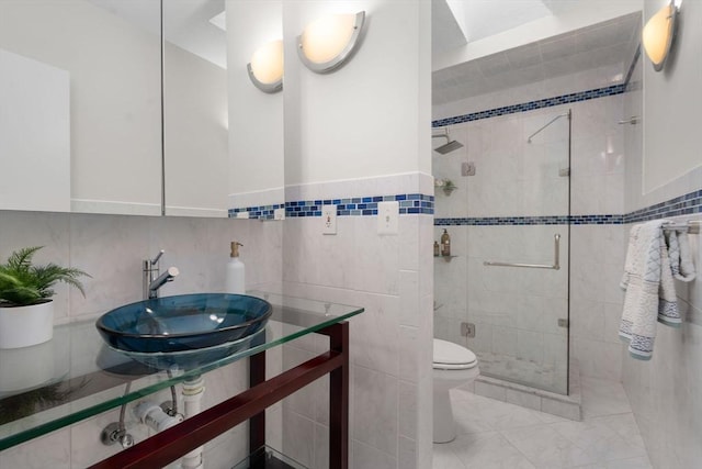 44 Fresh Pond Pl Unit 44, Cambridge, MA 02138 - bathroom with tile walls, toilet, a shower stall, a sink, and marble finish floors