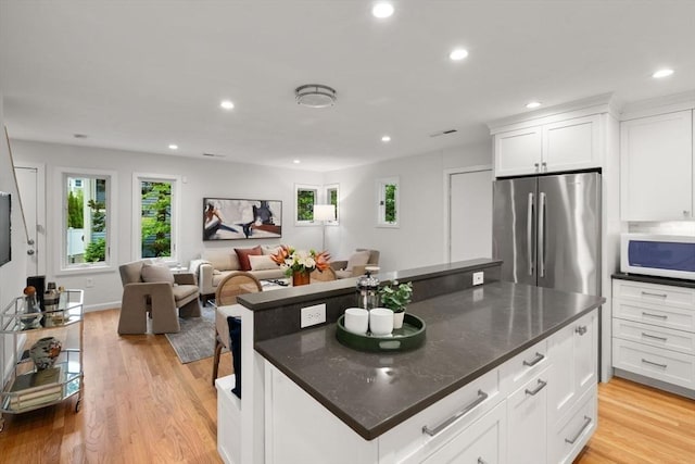 44 Fresh Pond Pl Unit 44, Cambridge, MA 02138 - kitchen with freestanding refrigerator, white microwave, healthy amount of natural light, light wood-style floors, and recessed lighting
