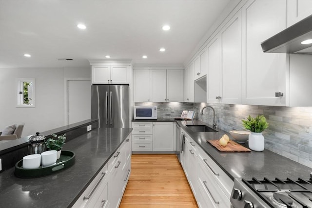 44 Fresh Pond Pl Unit 44, Cambridge, MA 02138 - kitchen featuring stainless steel appliances, a sink, extractor fan, white cabinetry, and recessed lighting