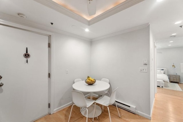 10 Beacon St Unit 105, Woburn, MA 01801 - dining space with a baseboard heating unit, light wood-type flooring, recessed lighting, crown molding, and baseboards