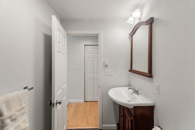 10 Beacon St Unit 105, Woburn, MA 01801 - bathroom with vanity, wood finished floors, and baseboards