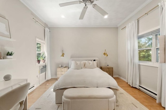 10 Beacon St Unit 105, Woburn, MA 01801 - bedroom featuring a baseboard heating unit, crown molding, a ceiling fan, light wood finished floors, and baseboards