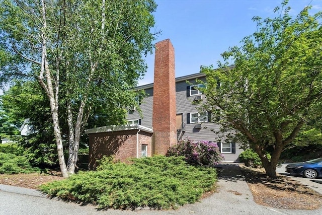 10 Beacon St Unit 105, Woburn, MA 01801 - view of front of house featuring a chimney