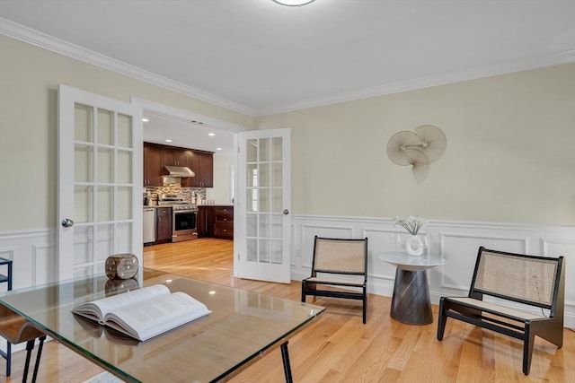 interior space featuring ornamental molding, french doors, and light wood-type flooring