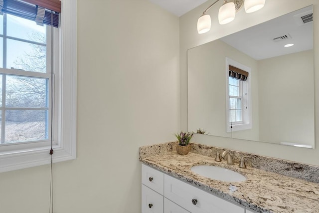 bathroom featuring vanity and a wealth of natural light