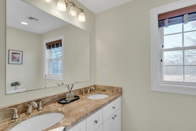 bathroom with plenty of natural light and vanity